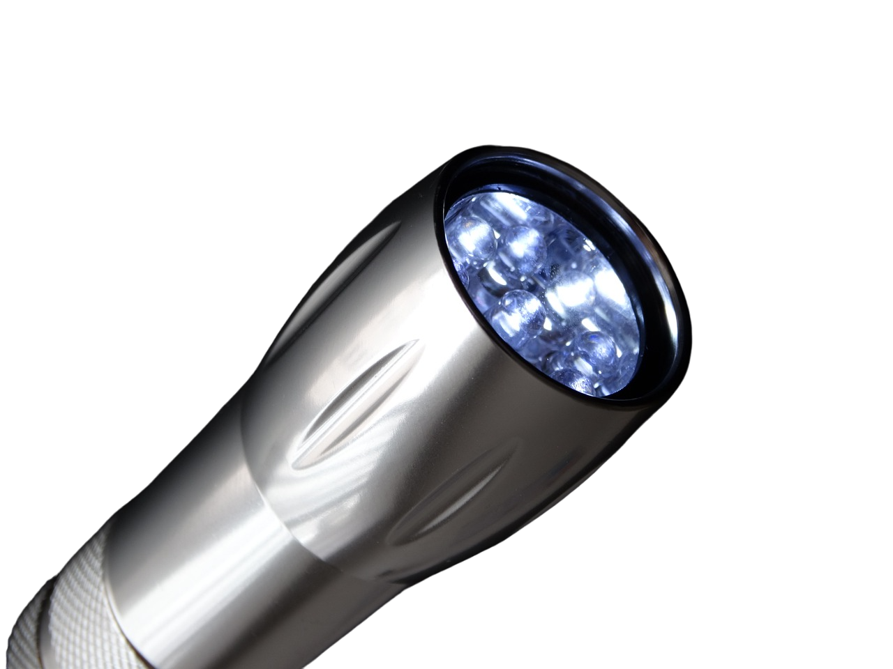 An image of a handheld flashlight with a sleek black body, emitting a bright beam of light from its LED bulb. The flashlight has a textured grip for easy handling and a simple on/off button near the top. It’s designed for portability, making it ideal for both indoor and outdoor use.